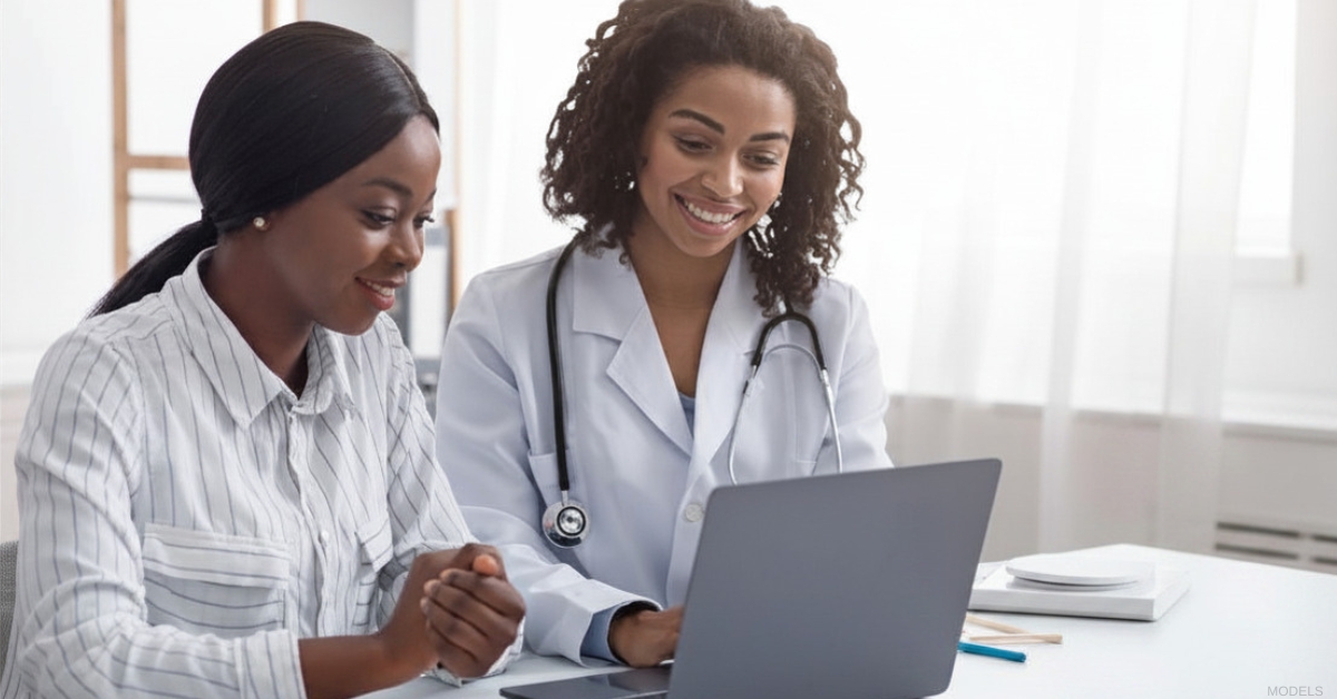 Patient consulting with a plastic surgeon about tummy tuck surgery (Model)