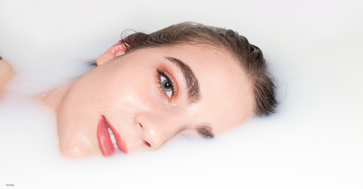 Woman lying on a bed with beautiful skin