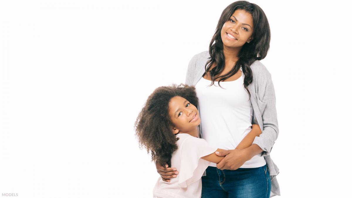 Mother hugging her daughter after experiencing the benefits of what the mommy makeover has to offer in Houston, TX.