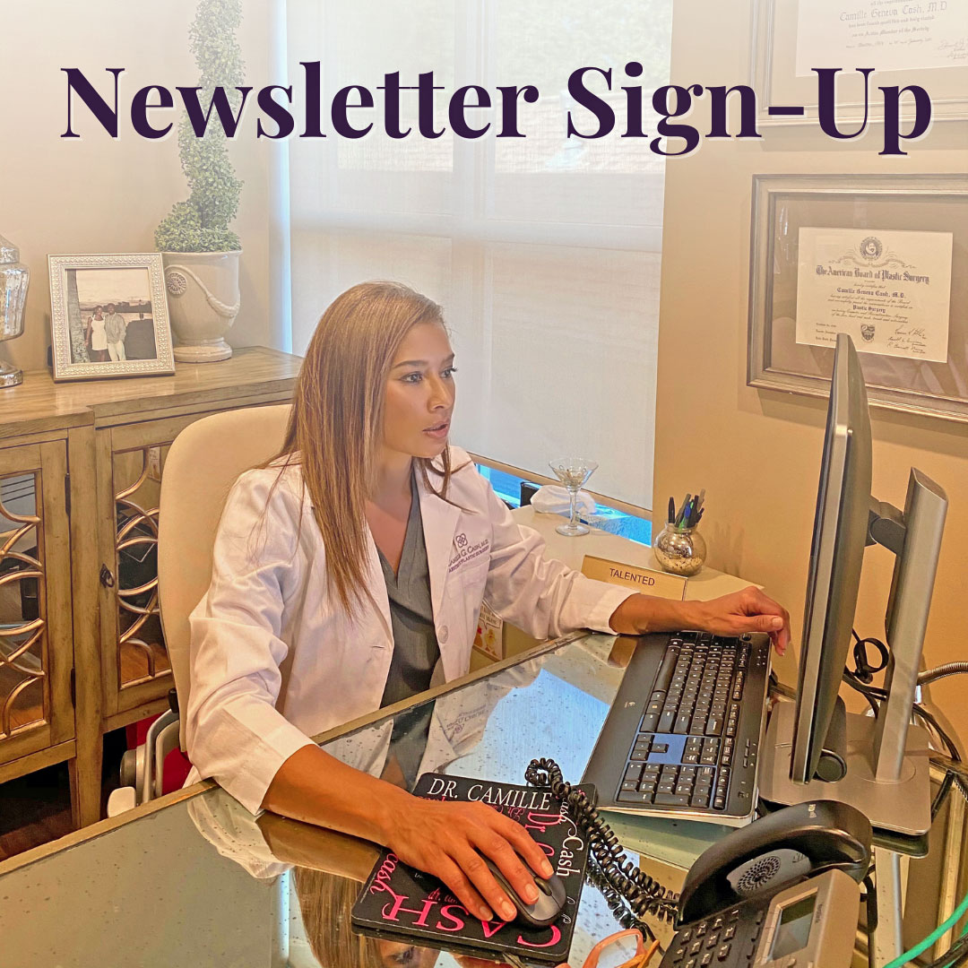 Double Board Certified Plastic Surgeon Camille Cash MD sitting at her desk typing a newsletter for Houston patients to sign up.