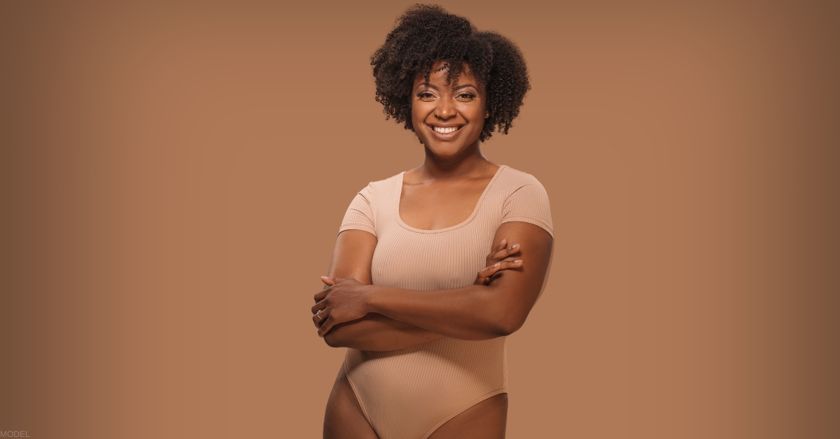 Woman after full tummy tuck recovery showing final results (Model)