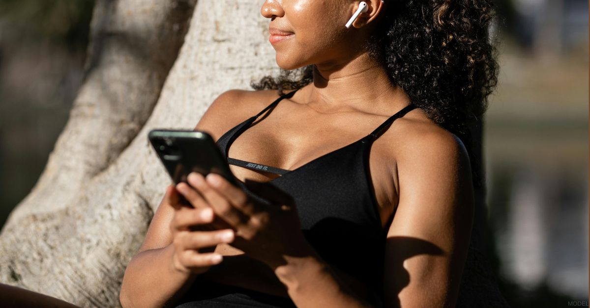 Woman researching breast implant sizing (model)