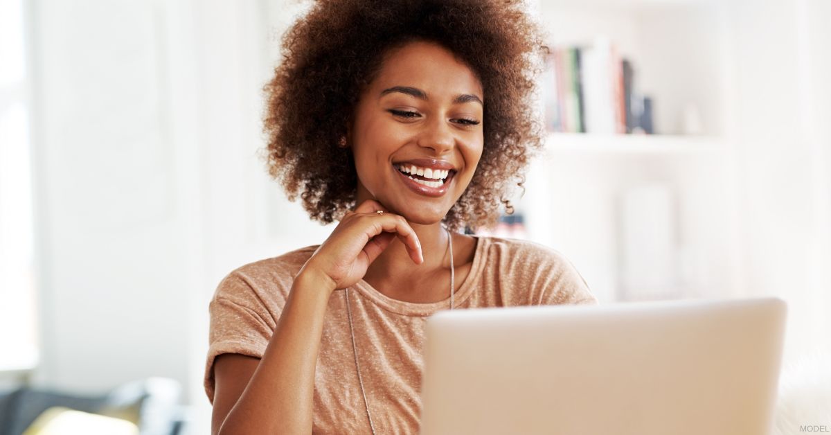 Woman researching plastic surgery options (model)