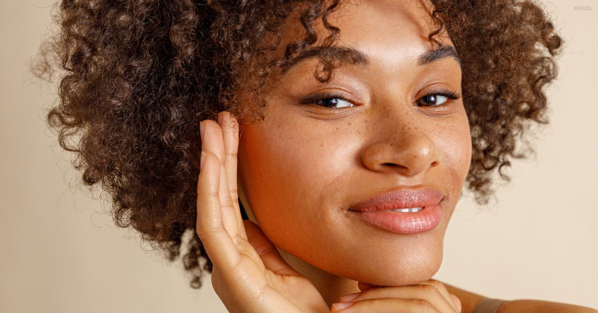 Woman touching her face (model)