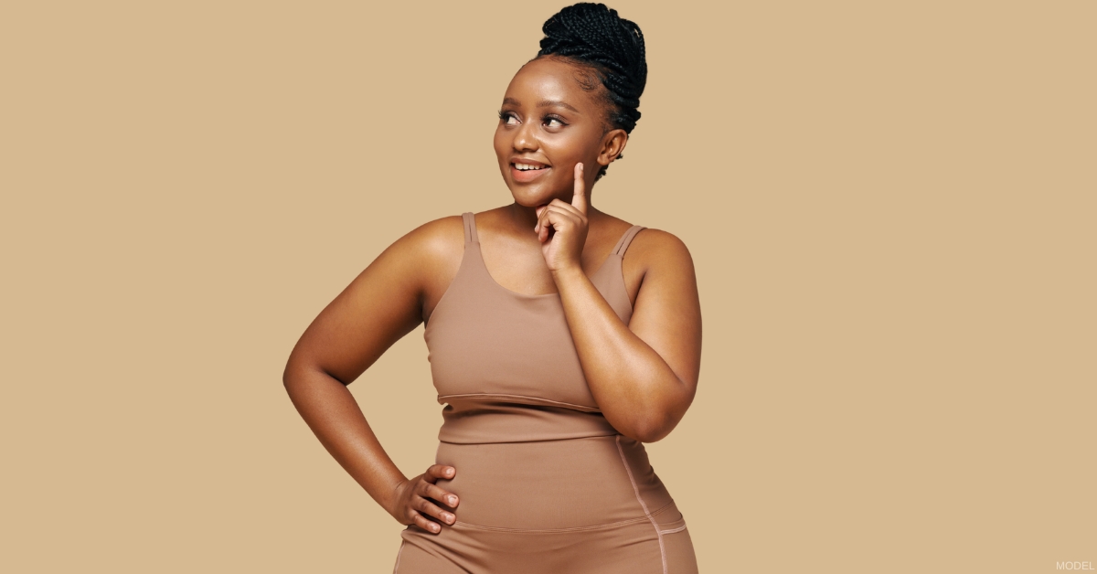 Woman showing post-weight-loss body contouring results (model)